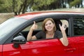 Attractive woman smiling proud sitting at driver seat holding and showing car key in new automobile buying and renting Royalty Free Stock Photo