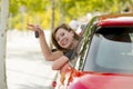 Attractive woman smiling proud sitting at driver seat holding and showing car key in new automobile buying and renting Royalty Free Stock Photo