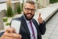 Young happy bearded businessman standing outside office building Royalty Free Stock Photo