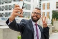 Young happy bearded businessman standing outside office building Royalty Free Stock Photo