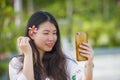 Young happy and beautiful Asian Chinese tourist woman taking selfie self portrait picture with mobile phone at tropical resort Royalty Free Stock Photo