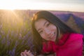 Young happy and beautiful Asian Chinese woman in Summer dress enjoying free and playful in romantic and lovely purple lavender