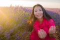 Young happy and beautiful Asian Japanese woman in Summer dress enjoying free and playful in romantic and lovely purple lavender