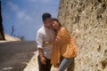 Young happy and beautiful Asian Korean couple in love enjoying outdoors romantic journey playing sweet in cliff rock road