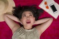 Young happy and beautiful Asian Korean student girl chilling on city park relaxed lying flat on sarong with mobile phone and book Royalty Free Stock Photo