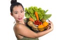 Young happy and beautiful Asian Korean woman holding basket full of fresh vegetables and fruits smiling cheerful  in healthy Royalty Free Stock Photo