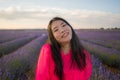 Young happy and beautiful Asian Korean woman in Summer dress enjoying nature running free and playful outdoors at purple lavender Royalty Free Stock Photo