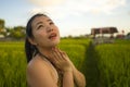 Young happy and beautiful Asian woman enjoying nature at rice field. sweet Chinese girl exploring countryside during holiday Royalty Free Stock Photo