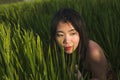 Young happy and beautiful Asian woman enjoying nature at rice field. sweet Chinese girl exploring countryside during holiday Royalty Free Stock Photo