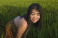 Young happy and beautiful Asian woman enjoying nature at rice field. sweet Chinese girl exploring countryside during holiday Royalty Free Stock Photo