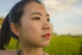 Young happy and beautiful Asian woman enjoying nature at rice field. sweet Korean girl exploring countryside during holiday travel Royalty Free Stock Photo