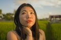 Young happy and beautiful Asian woman enjoying nature at rice field. sweet Korean girl exploring countryside during holiday travel Royalty Free Stock Photo