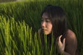 Young happy and beautiful Asian woman enjoying nature at rice field. sweet Korean girl exploring countryside during holiday travel Royalty Free Stock Photo