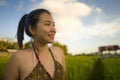 Young happy and beautiful Asian woman enjoying nature at rice field. sweet Korean girl exploring countryside during holiday travel Royalty Free Stock Photo