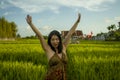 Young happy and beautiful Asian woman enjoying nature at rice field. sweet Korean girl exploring countryside during holiday travel Royalty Free Stock Photo
