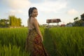 Young happy and beautiful Asian woman enjoying nature at rice field. sweet Korean girl exploring countryside during holiday travel Royalty Free Stock Photo