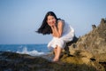 Young happy and beautiful Asian woman by the sea - Attractive Korean girl in white dress enjoying relaxed summer holidays at Royalty Free Stock Photo