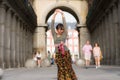 Young happy and beautiful Asian woman wearing traditional Balinese kebaya dress - Indonesian girl doing Bali dance on street
