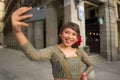 Young happy and beautiful Asian woman wearing traditional Balinese kebaya dress taking selfie - Indonesian girl in Bali clothes Royalty Free Stock Photo