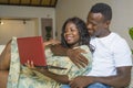 Young happy and beautiful black African American couple in love enjoying at living room sofa couch with laptop computer having fun Royalty Free Stock Photo