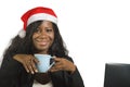 Young happy and beautiful black afro American business woman in Santa Christmas hat working at office computer desk smiling succes Royalty Free Stock Photo