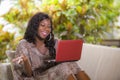 Young happy and beautiful black afro American woman in fashionable dress and working with laptop computer enjoying freelance Royalty Free Stock Photo