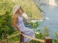 Young happy and beautiful blond woman relaxed at tropical beach cliff viewpoint enjoying Summer holidays getaway carefree at Royalty Free Stock Photo