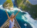 Young happy and beautiful blond woman relaxed at tropical beach cliff viewpoint enjoying Summer holidays getaway carefree at Royalty Free Stock Photo