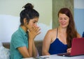 Young happy and beautiful caucasian and latin women working at office cafe with laptop computer discussing as digital business Royalty Free Stock Photo