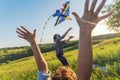 Young happy beautiful couple flying a kite in a summer field, summer happiness and love concept Royalty Free Stock Photo