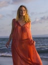 Oung happy beautiful and glamorous blond woman posing as at the beach wearing stylish dress smiling cheerful feeling fresh and fre Royalty Free Stock Photo