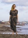 Young happy beautiful and glamorous blond woman posing as at the beach wearing stylish dress smiling cheerful feeling fresh and fr Royalty Free Stock Photo