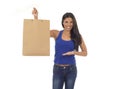 Young happy and beautiful hispanic woman holding brown shopping bag smiling excited isolated on white Royalty Free Stock Photo