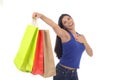 Young happy and beautiful hispanic woman holding color shopping bags smiling excited isolated