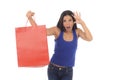 Young happy and beautiful hispanic woman holding red shopping bag smiling excited isolated on white Royalty Free Stock Photo