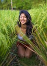 Young happy and beautiful latin woman smiling playful having fun posing sexy isolated on green rice field in Asia tourist trip and Royalty Free Stock Photo