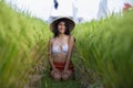 Young happy and beautiful latin woman in traditional Asian farmer hat smiling cheerful posing sexy isolated on green rice field in Royalty Free Stock Photo