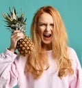 Young happy beautiful woman posing laughing with pineapple fruit Royalty Free Stock Photo