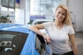 Beautiful young woman buying new car at the dealership Royalty Free Stock Photo