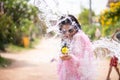 Young happy beauty Asian girl with water gun wearing summer shirt in Songkran festival - water festival in Thailand Royalty Free Stock Photo