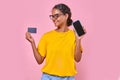 Young happy beauty Indian woman teenager with phone and credit card for payment Royalty Free Stock Photo