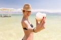 Young happy bikini woman holding salt chunk, Dead sea, Israel. Royalty Free Stock Photo