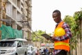 Young happy black African man construction worker smiling while Royalty Free Stock Photo