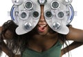 Young and happy black afro American woman at hospital looking through optometric hospital device checking eyes having sight exam