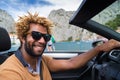 Happy black man driving a convertible car. Royalty Free Stock Photo