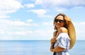 Young happy blond woman at beautiful tropical paradise view of ocean enjoying summer holidays