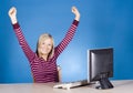 Young happy blonde woman at the computer