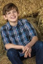 Young Happy Boy Smiling on Hay Bales Royalty Free Stock Photo