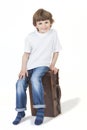 Young Happy Boy Smiling Sitting on Suitcase Royalty Free Stock Photo