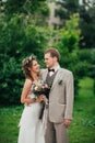 Young happy bride and groom on the background of greenery Royalty Free Stock Photo